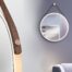 MIRROH smart bathroom mirror displaying a digital interface in a modern real estate bathroom setting